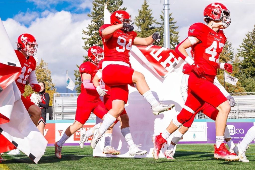 Marcus Fry (#94) bursts through the breakaway banner as the Westshore Rebels take the field for their Cullen Cup semifinal against the Prince George Kodiaks.
